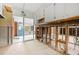 View of the kitchen with walls undergoing renovation, white cabinets and a sliding glass door at 2812 Miriam S St, Gulfport, FL 33711