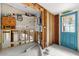 View of the laundry room with walls being renovated and a blue exterior door at 2812 Miriam S St, Gulfport, FL 33711