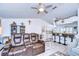 Open living room features a brown leather reclining sofa and a view into the kitchen at 29330 Schinnecock Hills Ln, San Antonio, FL 33576