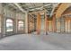 Interior framing of a large room during new construction, with arched doorways and windows at 309 Pruett Rd, Seffner, FL 33584