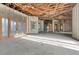 Open floor plan interior with high ceilings, large windows, and exposed beams, currently under construction at 309 Pruett Rd, Seffner, FL 33584