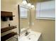 Updated bathroom with vanity, mirror, and shelving at 3148 Harvardston Loop, Holiday, FL 34691