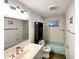 Bathroom with light teal tub, updated vanity, and tiled floors at 3148 Harvardston Loop, Holiday, FL 34691