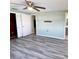 Primary bedroom with wood-look flooring and a large closet at 3148 Harvardston Loop, Holiday, FL 34691
