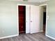 Bedroom with wood-look flooring and built-in closet at 3148 Harvardston Loop, Holiday, FL 34691