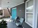 Gray house with teal garage door and front porch at 3148 Harvardston Loop, Holiday, FL 34691