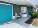 Gray house with teal garage door, landscaping, and driveway at 3148 Harvardston Loop, Holiday, FL 34691
