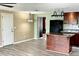 Kitchen with island, wood cabinets, and vinyl flooring at 3148 Harvardston Loop, Holiday, FL 34691