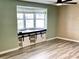 Living room featuring a built-in window seat and wood-look flooring at 3148 Harvardston Loop, Holiday, FL 34691