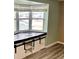 Living room with a built-in window seat and wood-look flooring at 3148 Harvardston Loop, Holiday, FL 34691