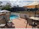 Wooden deck with above-ground pool, table, and chairs at 3148 Harvardston Loop, Holiday, FL 34691