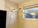 Shower with beige tile surround and handheld showerhead at 3148 Harvardston Loop, Holiday, FL 34691