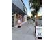 Street view showcasing shops and palm trees along the sidewalk at 3148 Harvardston Loop, Holiday, FL 34691