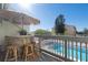 Private balcony with rattan furniture and pool view at 318 Windrush Blvd # 10, Indian Rocks Beach, FL 33785