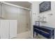 Clean bathroom with shower/tub combo, vanity, and linen storage at 318 Windrush Blvd # 10, Indian Rocks Beach, FL 33785