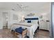 Main bedroom with king-size bed, white dresser, and ceiling fan at 318 Windrush Blvd # 10, Indian Rocks Beach, FL 33785
