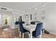 Bright dining room with white table and blue chairs at 318 Windrush Blvd # 10, Indian Rocks Beach, FL 33785