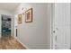 Bright hallway with light wood floors and framed art at 318 Windrush Blvd # 10, Indian Rocks Beach, FL 33785