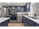 Modern kitchen featuring stainless steel appliances and navy blue cabinets at 318 Windrush Blvd # 10, Indian Rocks Beach, FL 33785