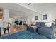 Living room with sectional sofa and blue rug, open to dining area at 318 Windrush Blvd # 10, Indian Rocks Beach, FL 33785