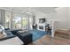 Spacious living room with sectional sofa, fireplace, and access to balcony at 318 Windrush Blvd # 10, Indian Rocks Beach, FL 33785