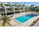 Community pool with patio and surrounding townhomes at 318 Windrush Blvd # 10, Indian Rocks Beach, FL 33785