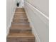 Light wood stairs leading to upper level at 318 Windrush Blvd # 10, Indian Rocks Beach, FL 33785