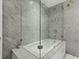 Elegant bathroom with a large soaking tub and glass shower enclosure at 3301 W Morrison Ave, Tampa, FL 33629