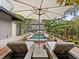 Two loungers under an umbrella facing the refreshing pool at 3301 W Morrison Ave, Tampa, FL 33629