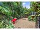 Relaxing backyard with a red bench and lush tropical plants at 3460 Reserve N Cir, St Petersburg, FL 33713