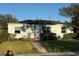 Light blue house with a yard, walkway, and small porch at 401 Columbia Dr, Tampa, FL 33606