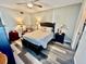Bright bedroom with a double bed, nightstands, and wood floors at 5207 Turquoise Ln # 202, New Port Richey, FL 34652