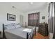 Simple bedroom with a bed, dresser, and guitar at 5570 4Th N Ave, St Petersburg, FL 33710