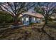 Charming single-story home showcasing a cozy front porch at dusk at 5570 4Th N Ave, St Petersburg, FL 33710