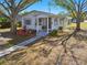 Charming bungalow with a well-manicured lawn and a welcoming front porch at 5570 4Th N Ave, St Petersburg, FL 33710