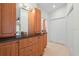 Bathroom with wood cabinets, granite countertops, and a large mirror at 6000 51St S St, St Petersburg, FL 33715