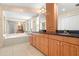 Elegant bathroom with double vanity, soaking tub, and large mirror at 6000 51St S St, St Petersburg, FL 33715