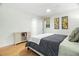 Cozy bedroom featuring a queen-size bed and light wood floors at 6000 51St S St, St Petersburg, FL 33715