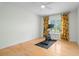Light and airy bedroom with a stationary bike and wood floors at 6000 51St S St, St Petersburg, FL 33715