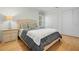 Bright bedroom with a comfortable bed and light wood floors at 6000 51St S St, St Petersburg, FL 33715