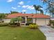 Single-story home with tile roof, and a well-maintained lawn at 6000 51St S St, St Petersburg, FL 33715