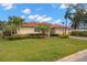 Single story home with tile roof, palm trees and landscaped yard at 6000 51St S St, St Petersburg, FL 33715