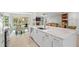 Spacious kitchen with white cabinets, large island, and stainless steel appliances at 6000 51St S St, St Petersburg, FL 33715