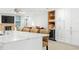 Spacious kitchen with large island, white cabinets, and wine fridge at 6000 51St S St, St Petersburg, FL 33715