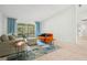 Living area with orange couch and access to patio at 6000 51St S St, St Petersburg, FL 33715