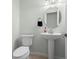 Small, updated powder room with pedestal sink and toilet at 6000 51St S St, St Petersburg, FL 33715
