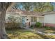 Front view of the house with porch and landscaping at 6410 78Th N Ave, Pinellas Park, FL 33781