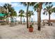 Relaxing beachfront patio area with tables and umbrellas at 880 Mandalay Ave # C1103, Clearwater Beach, FL 33767