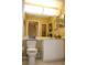 Well-lit bathroom with toilet and white vanity at 7108 Saint Andrews Ln, Sarasota, FL 34243