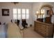 Spacious bedroom with a dresser and large window at 7108 Saint Andrews Ln, Sarasota, FL 34243